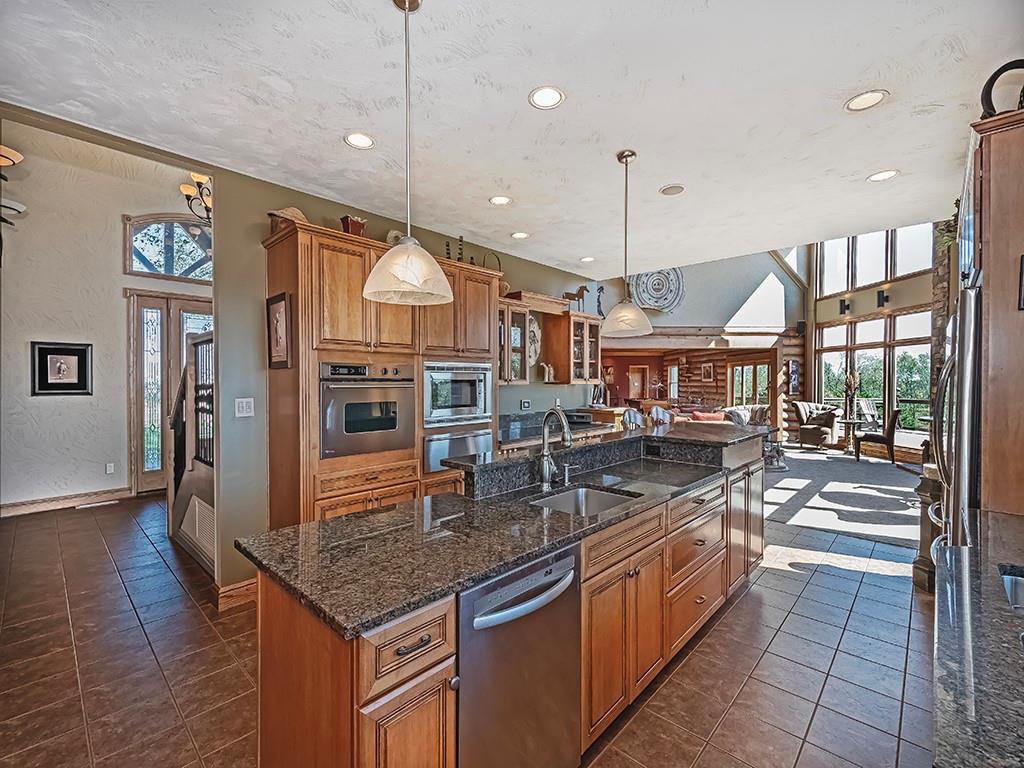 166 McKay Road Saxonburg, PA 16056 - Photo 12 of 48 a kitchen with stainless steel appliances granite countertop a kitchen island a stove a sink and a refrigerator