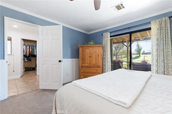 a bedroom with a large bed and a large window
