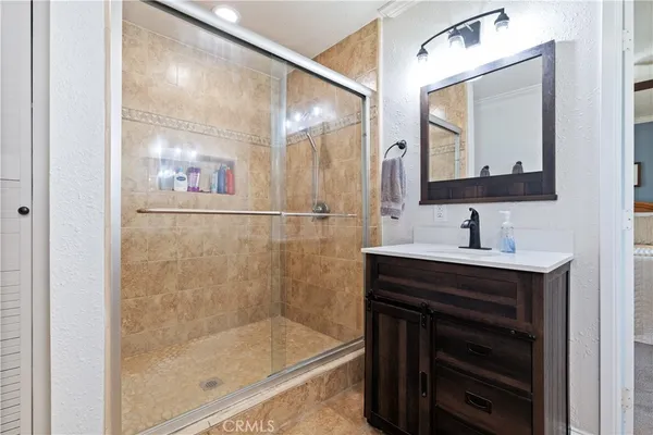 a bathroom with a sink a mirror a vanity and bathtub