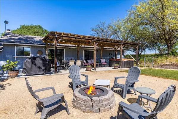 a view of a patio with dining table and chairs with plants
