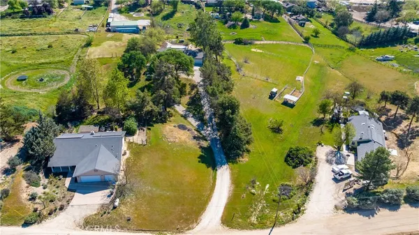 an aerial view of a residential houses with outdoor space