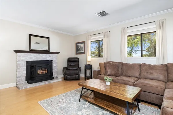 a living room with furniture a rug and a fireplace
