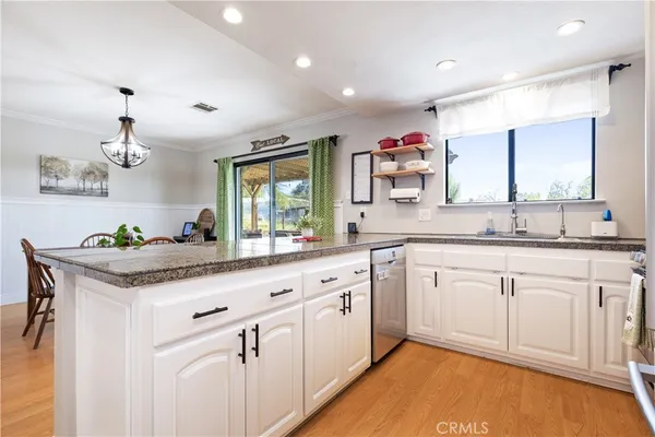 a kitchen with granite countertop counter space a sink and cabinets