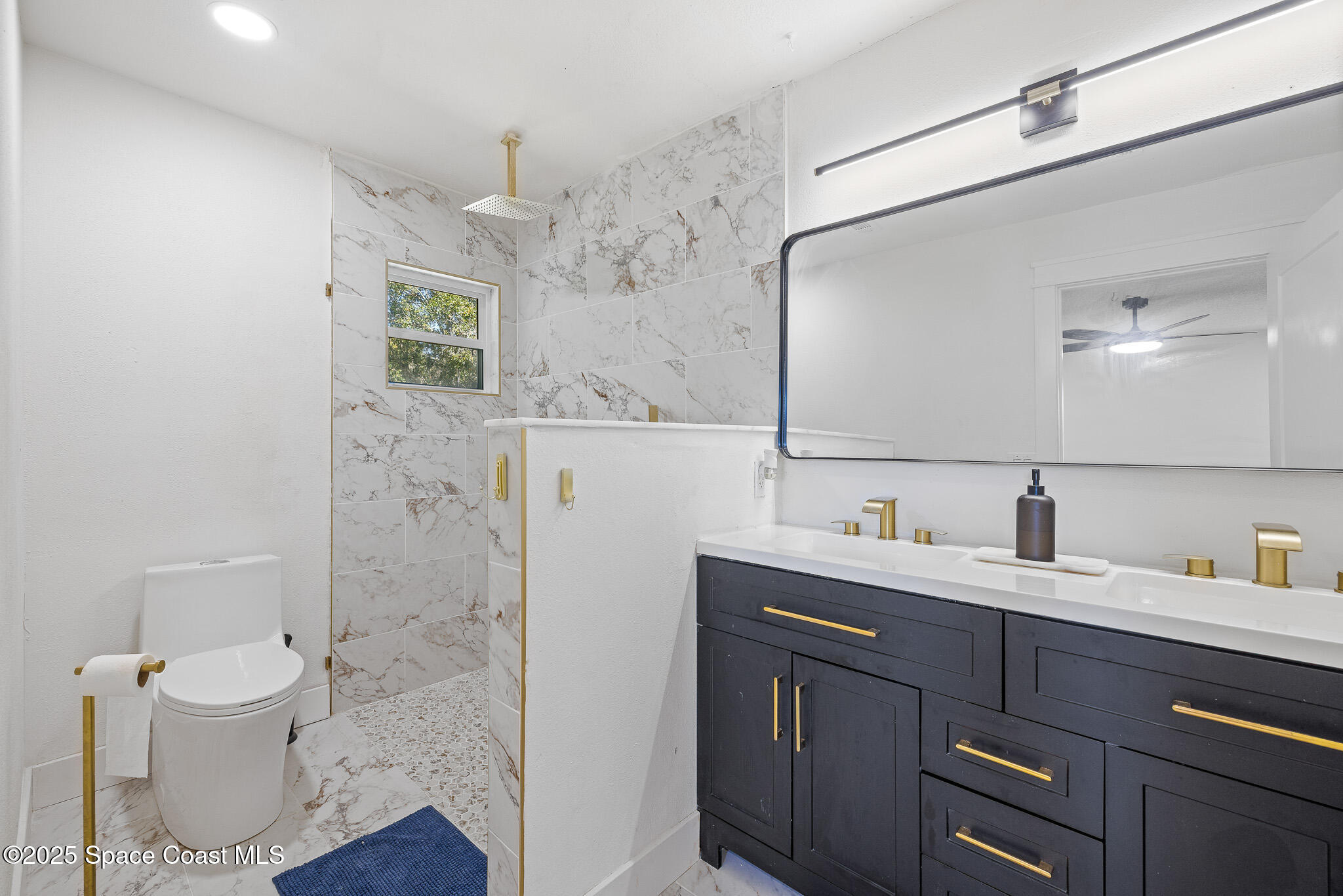 1274 Cimarron Circle Northeast Palm Bay, FL 32905 - Photo 14 of 37 a bathroom with a sink a toilet and shower