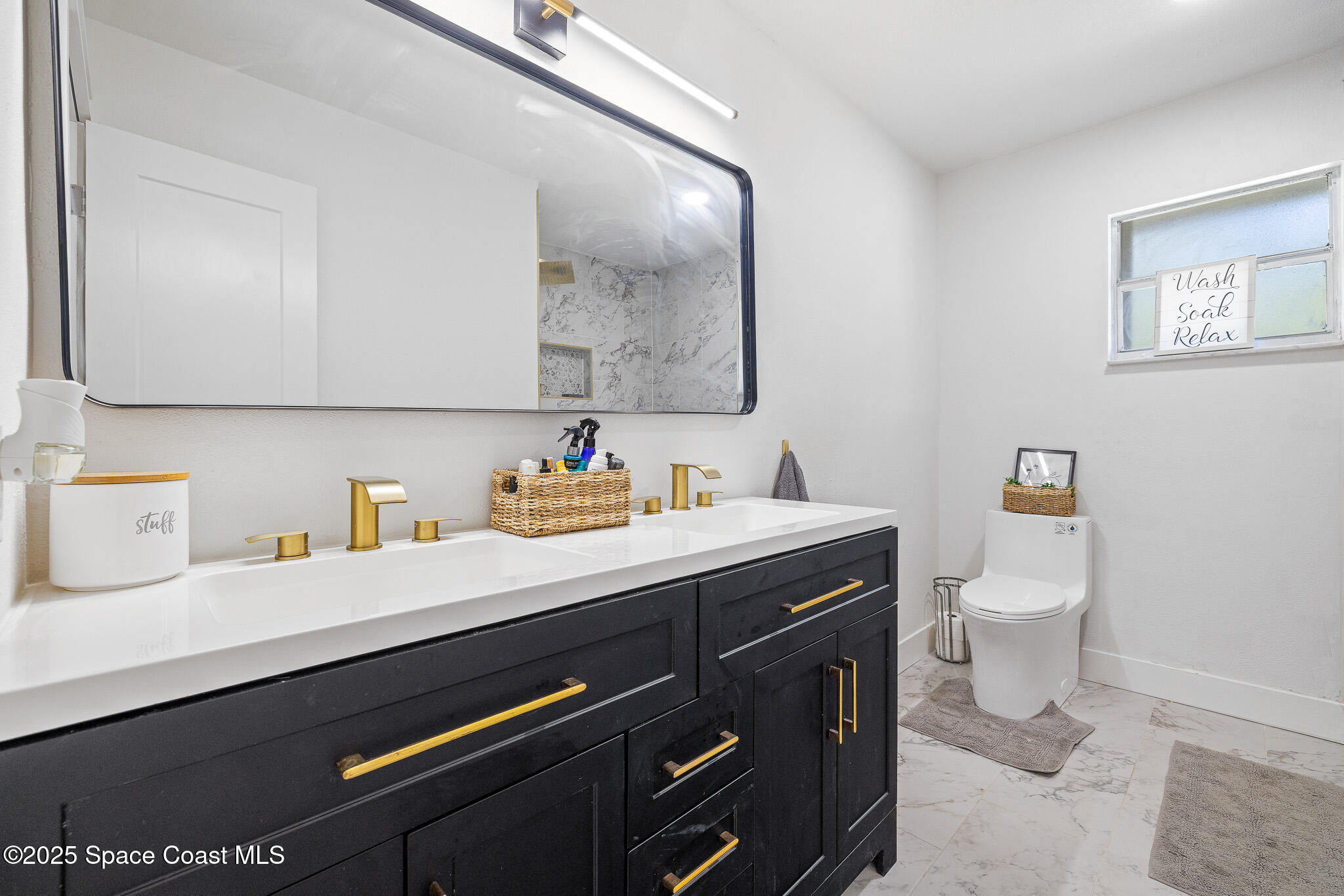 1274 Cimarron Circle Northeast Palm Bay, FL 32905 - Photo 15 of 37 a bathroom with a granite countertop sink a toilet and a mirror