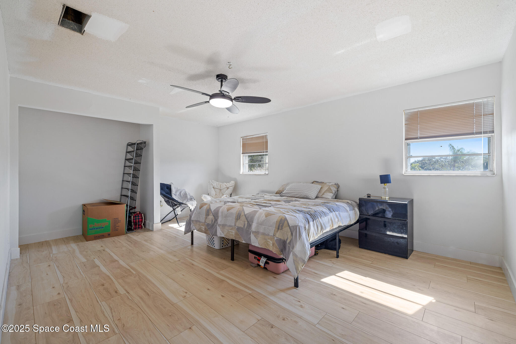 1274 Cimarron Circle Northeast Palm Bay, FL 32905 - Photo 16 of 37 a bedroom with a bed and a chandelier