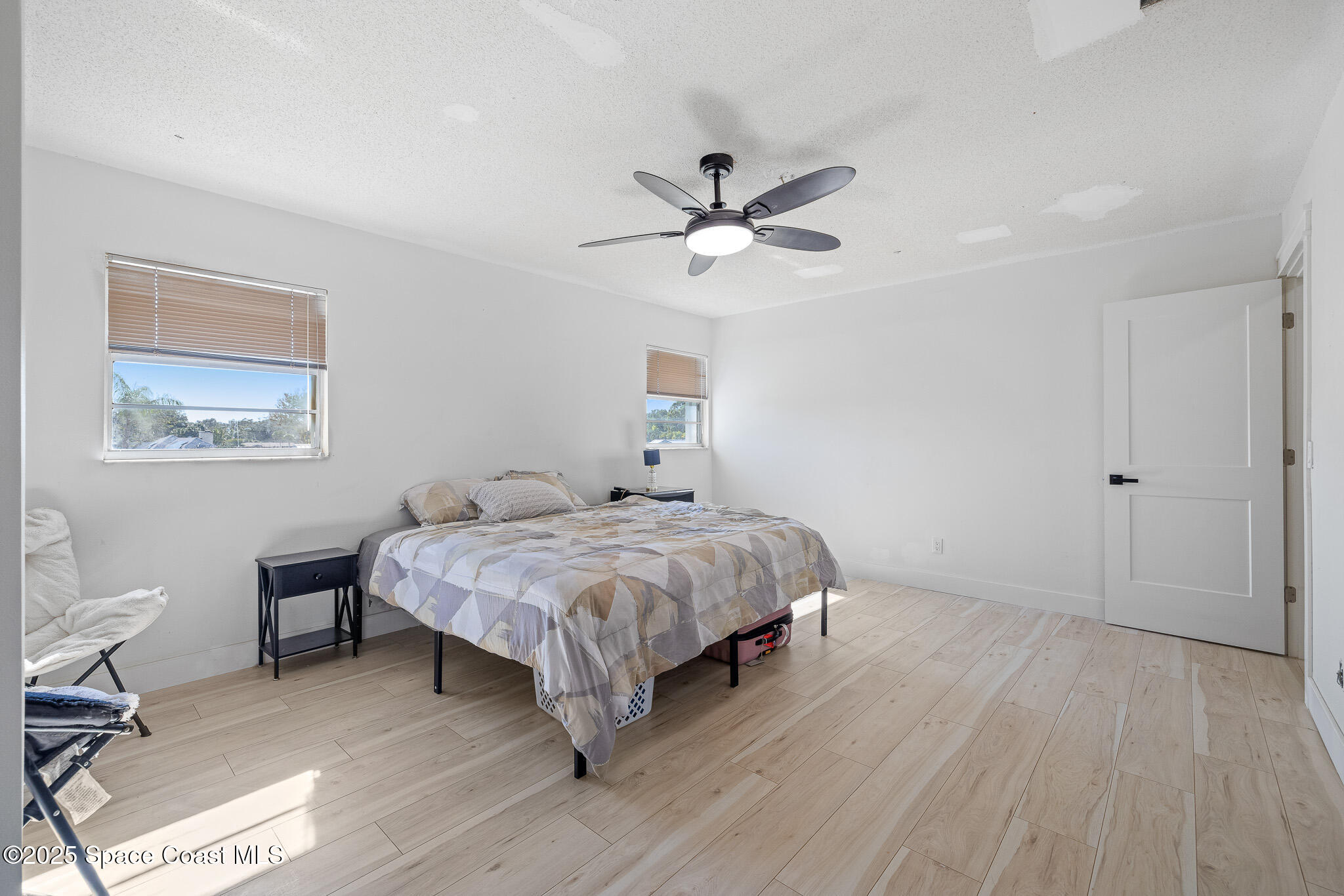 1274 Cimarron Circle Northeast Palm Bay, FL 32905 - Photo 17 of 37 a bedroom with a bed chandelier and a window
