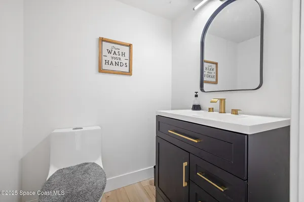 a bathroom with a sink vanity and a mirror