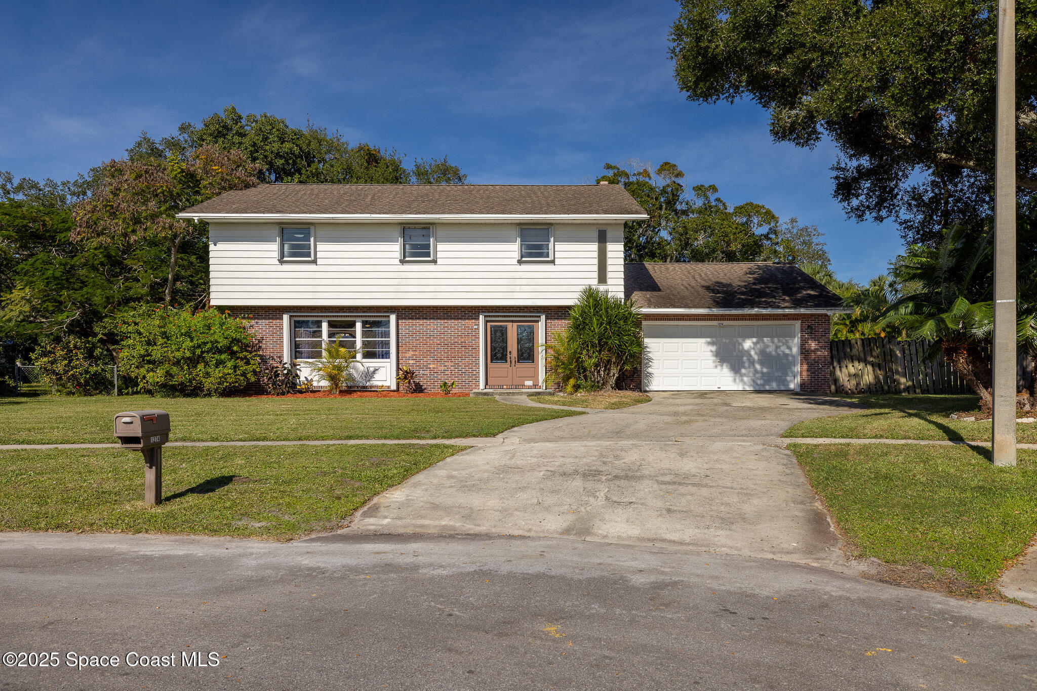 1274 Cimarron Circle Northeast Palm Bay, FL 32905 - Photo 23 of 37 a front view of a house with a yard