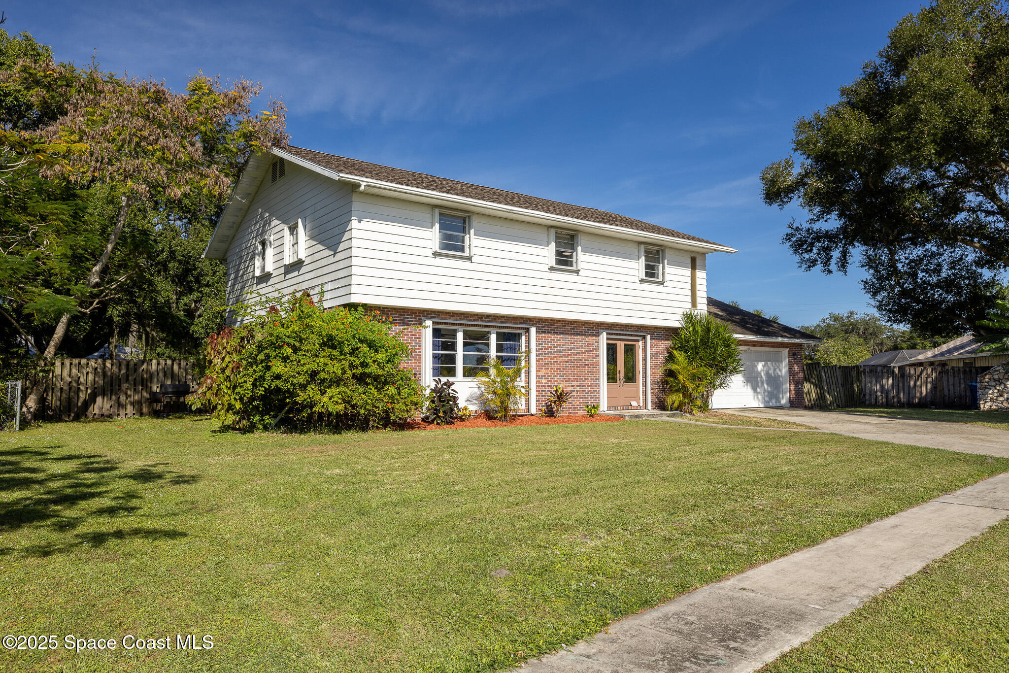 1274 Cimarron Circle Northeast Palm Bay, FL 32905 - Photo 25 of 37 a front view of a house with a garden