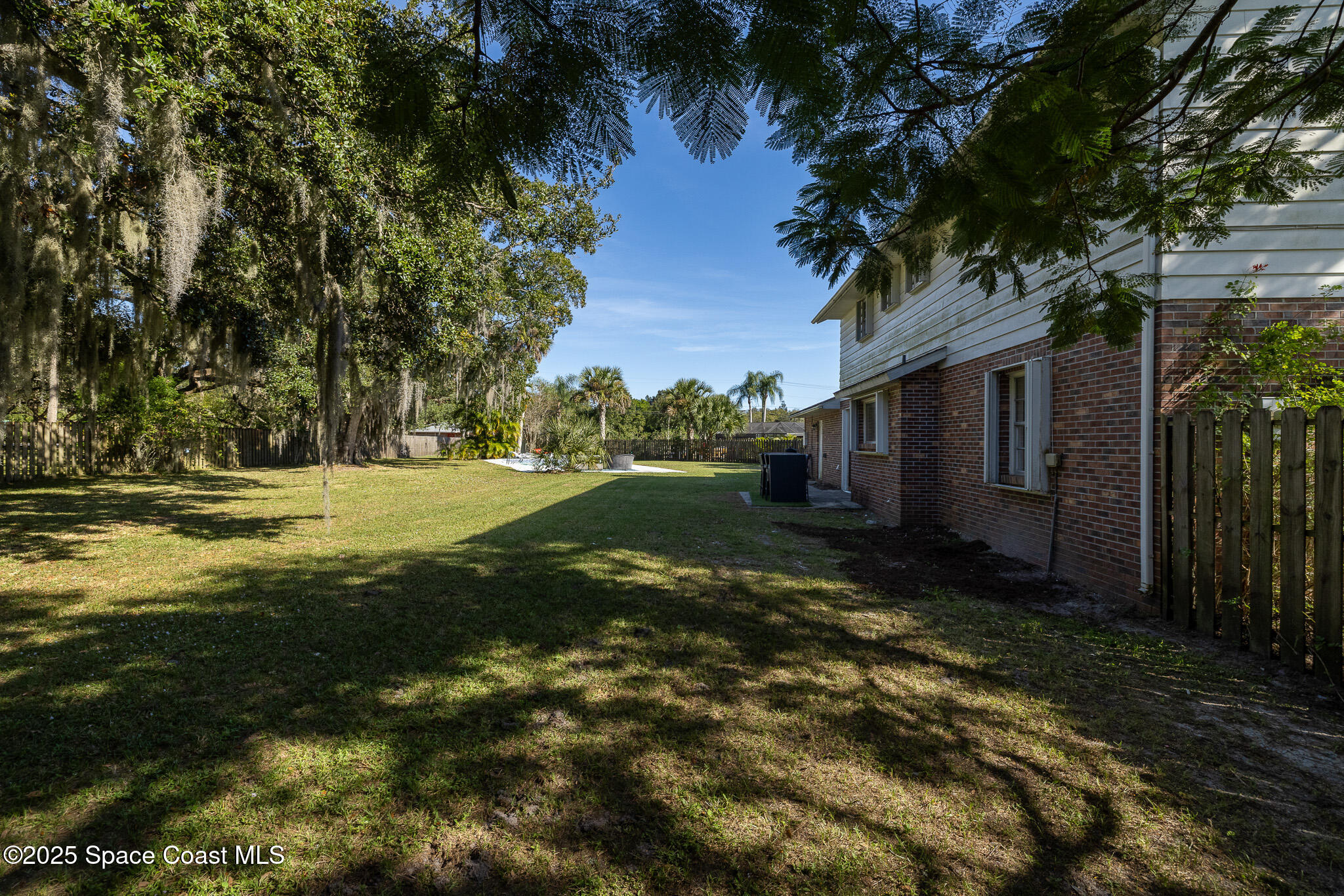 1274 Cimarron Circle Northeast Palm Bay, FL 32905 - Photo 29 of 37 a view of a house with a yard