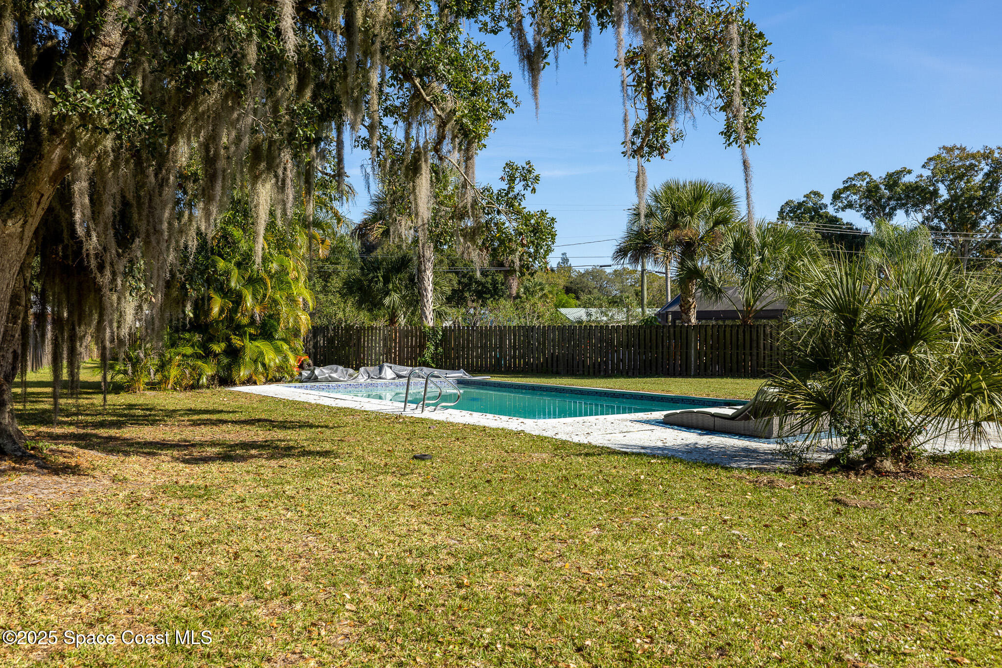1274 Cimarron Circle Northeast Palm Bay, FL 32905 - Photo 31 of 37 a view of a yard with palm trees