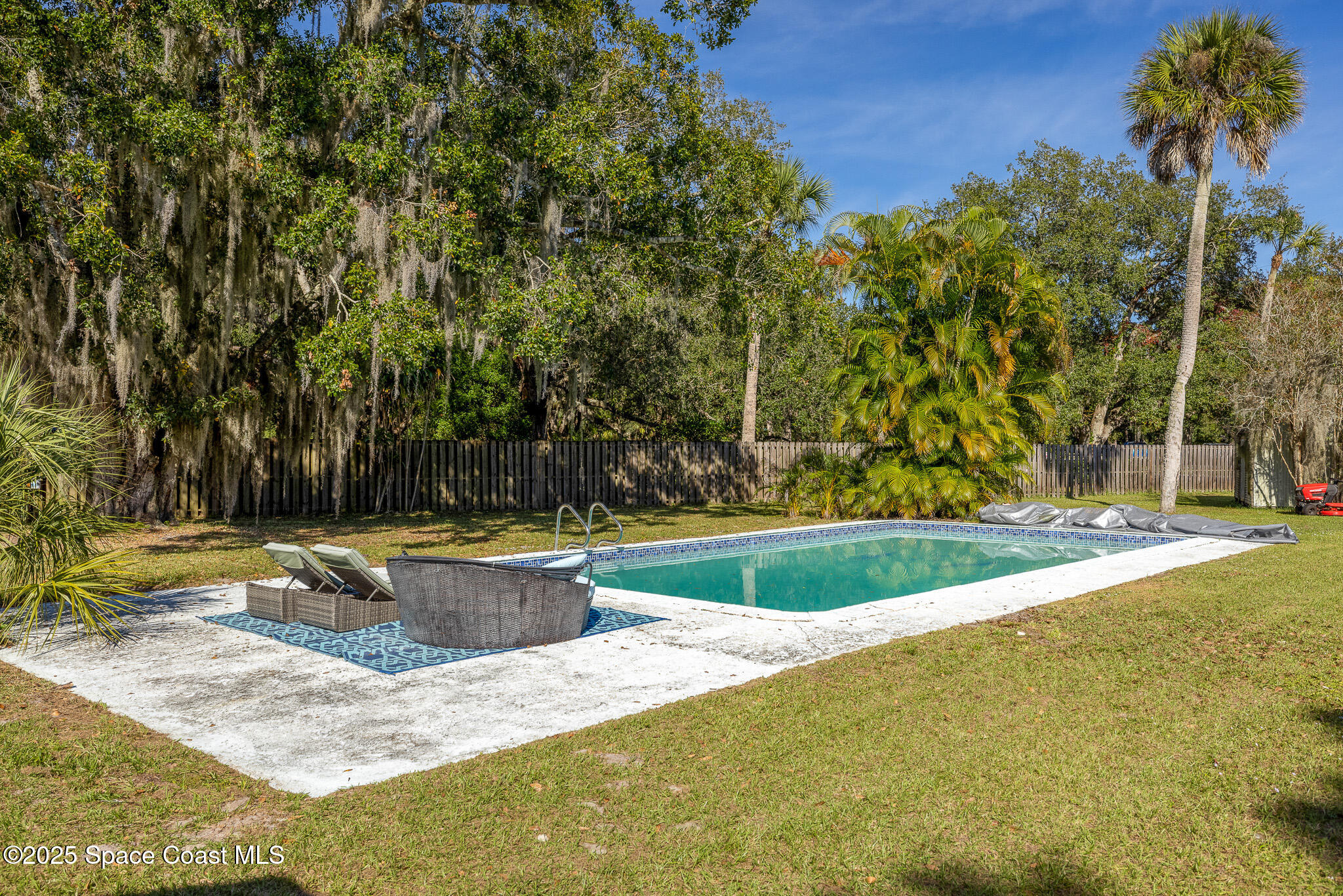 1274 Cimarron Circle Northeast Palm Bay, FL 32905 - Photo 33 of 37 a view of a swimming pool with a patio