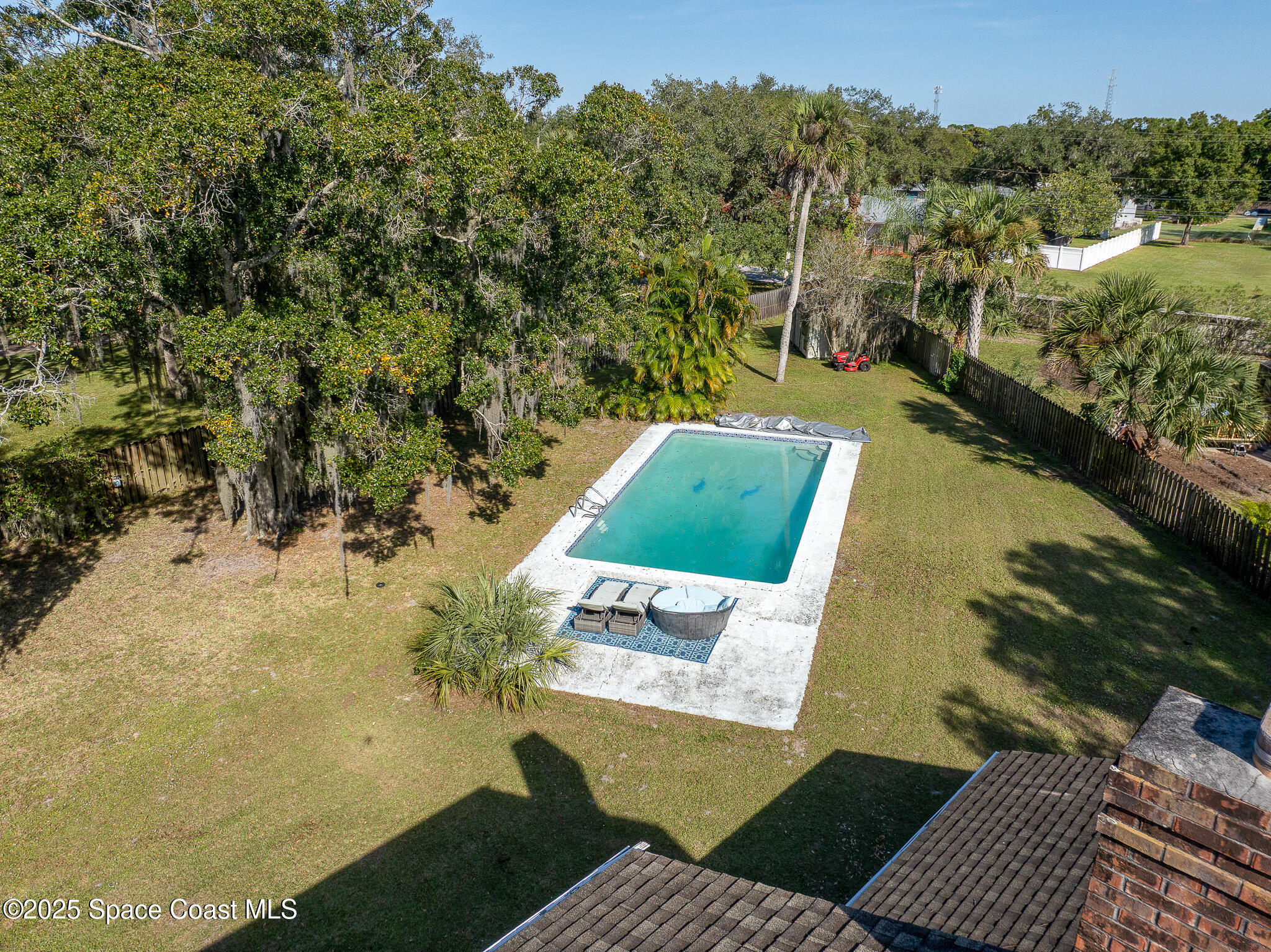 1274 Cimarron Circle Northeast Palm Bay, FL 32905 - Photo 35 of 37 an aerial view of a house with a yard and lake view