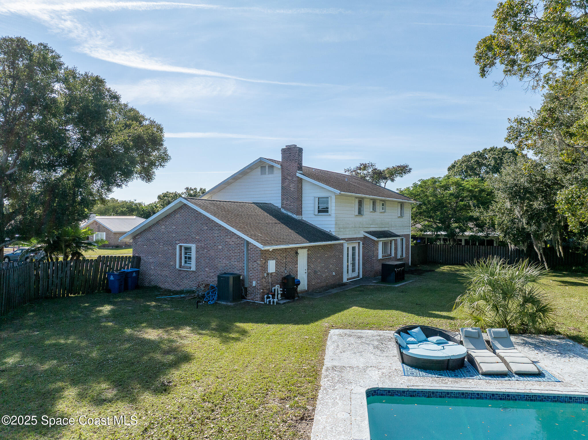 1274 Cimarron Circle Northeast Palm Bay, FL 32905 - Photo 36 of 37 a aerial view of a house with a yard table and chairs