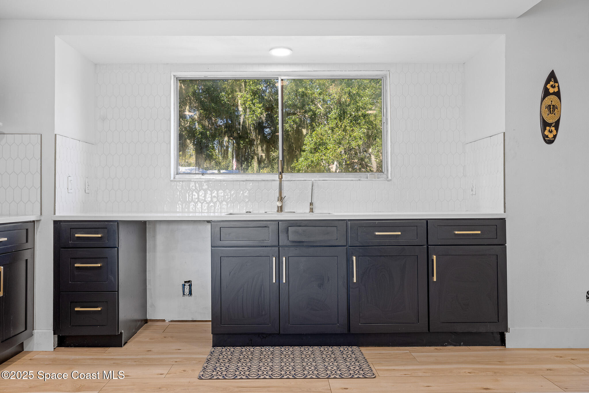 1274 Cimarron Circle Northeast Palm Bay, FL 32905 - Photo 5 of 37 a kitchen with a sink and cabinets