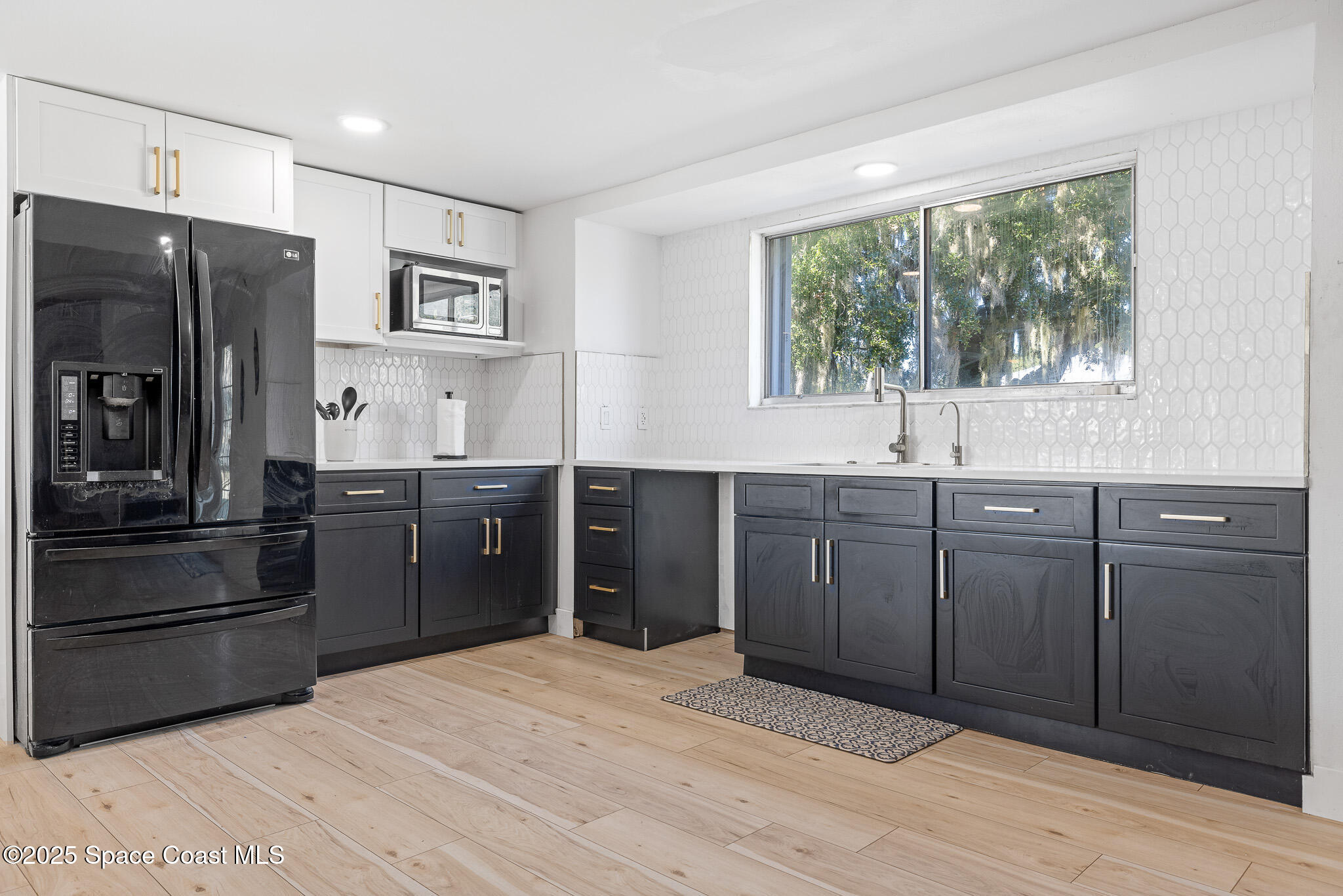 1274 Cimarron Circle Northeast Palm Bay, FL 32905 - Photo 6 of 37 a kitchen with stainless steel appliances granite countertop a refrigerator and a sink