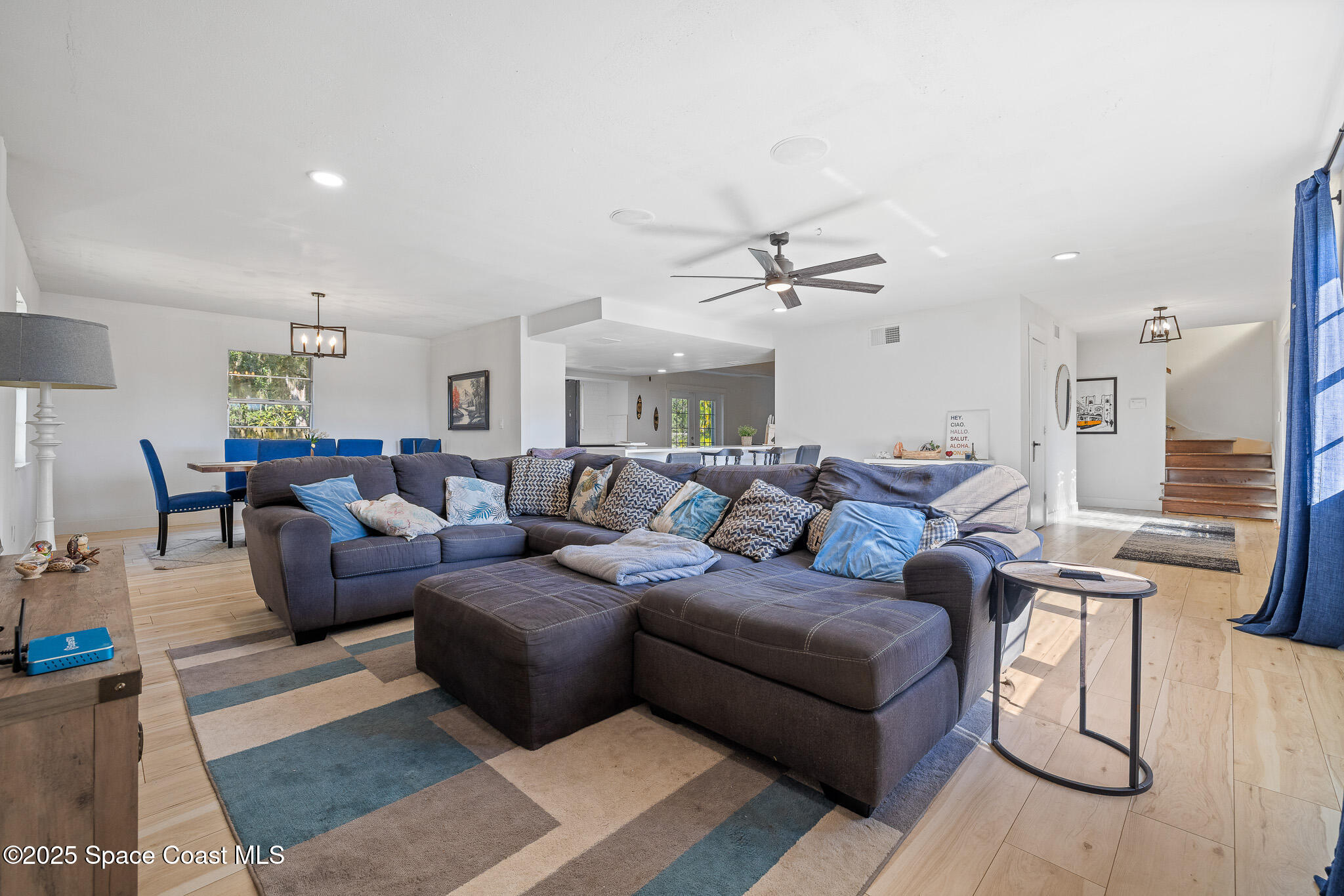 1274 Cimarron Circle Northeast Palm Bay, FL 32905 - Photo 7 of 37 a living room with furniture and a view of kitchen