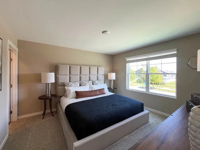 a bedroom with a bed and window