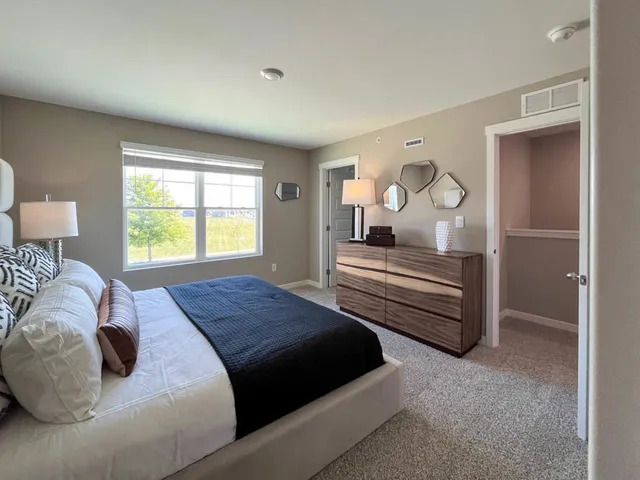 a bedroom with a bed and a window