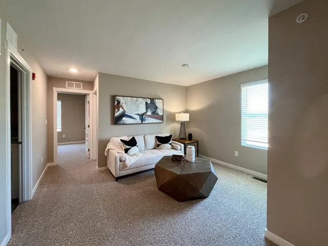 a living room with furniture and a potted plant