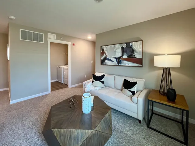 a living room with furniture and a lamp