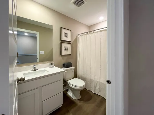 a bathroom with a toilet sink and a mirror
