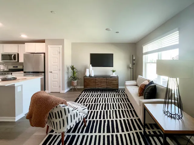 a bedroom with furniture and a flat screen tv