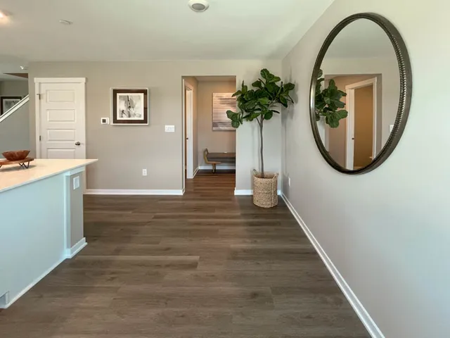 a view of a livingroom with wooden floor and entryway