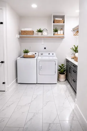 a utility room with cabinets washer and dryer