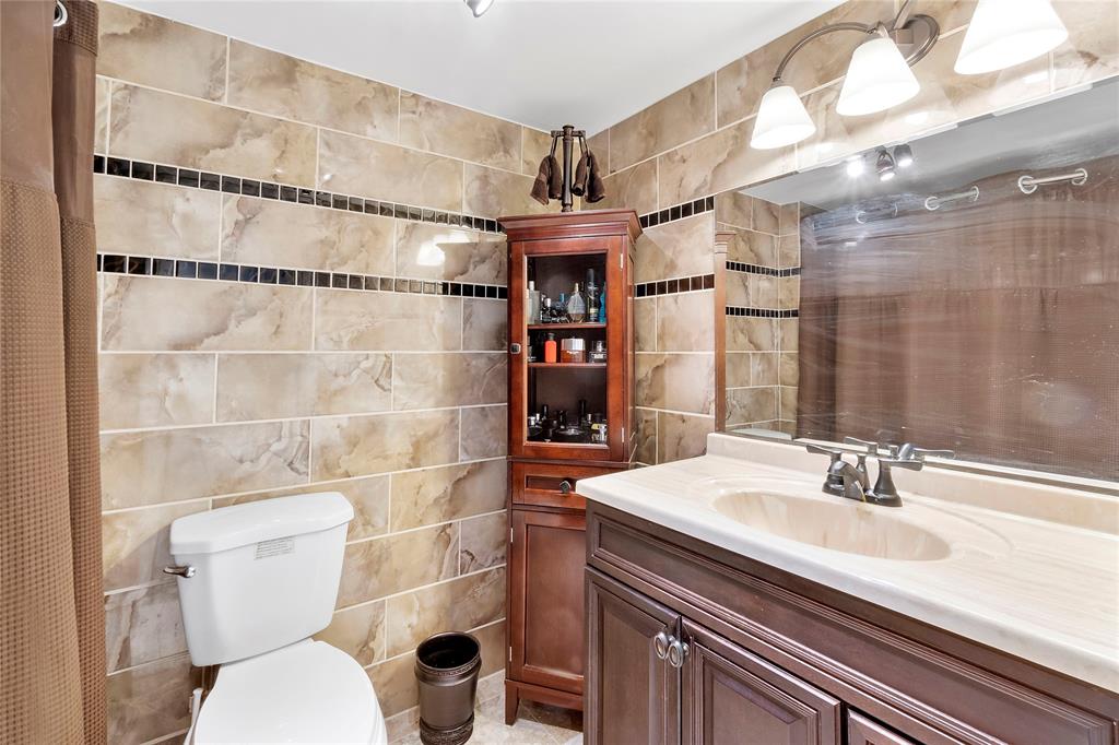 9856 Marina Boulevard, Unit 1311 Boca Raton, FL 33428 - Photo 11 of 26 a bathroom with a sink toilet and shower