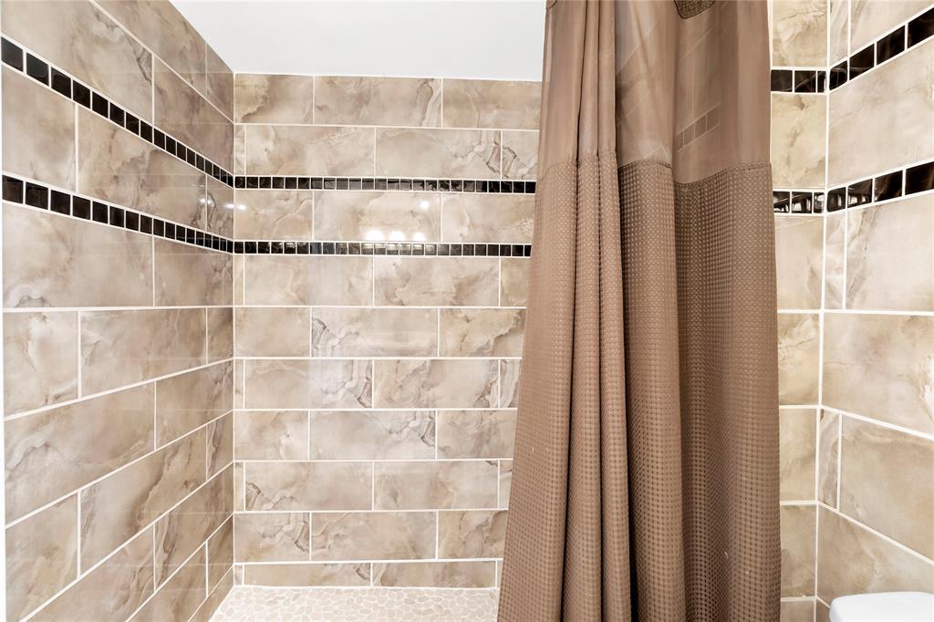 9856 Marina Boulevard, Unit 1311 Boca Raton, FL 33428 - Photo 12 of 26 a bathroom with a glass shower door