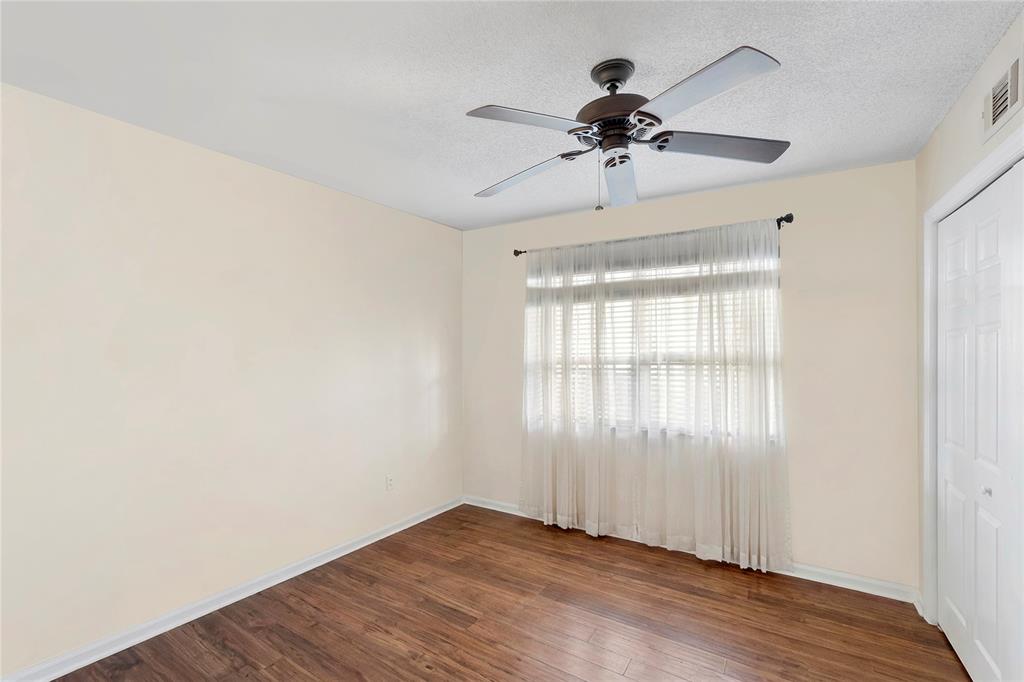 9856 Marina Boulevard, Unit 1311 Boca Raton, FL 33428 - Photo 13 of 26 a view of an empty room with wooden floor and a window
