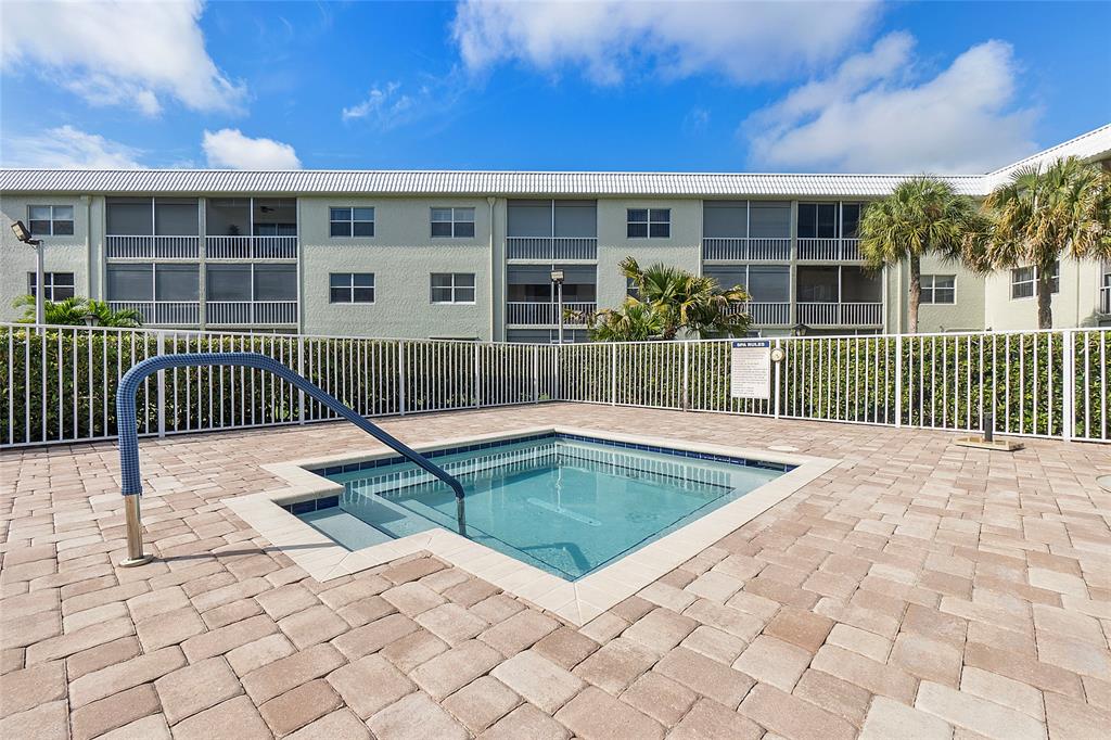 9856 Marina Boulevard, Unit 1311 Boca Raton, FL 33428 - Photo 25 of 26 a view of a house with a small yard and wooden fence