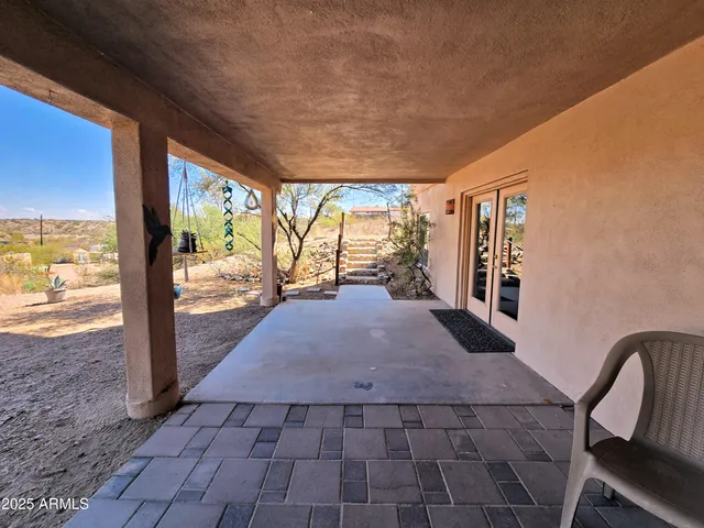 a view of porch with furniture and floor to ceiling window