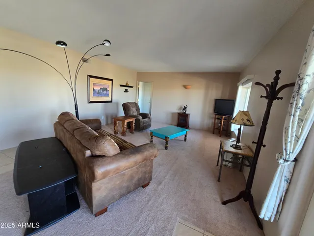 a living room with furniture and a mirror