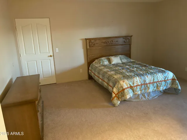 a bedroom with a bed and a chair