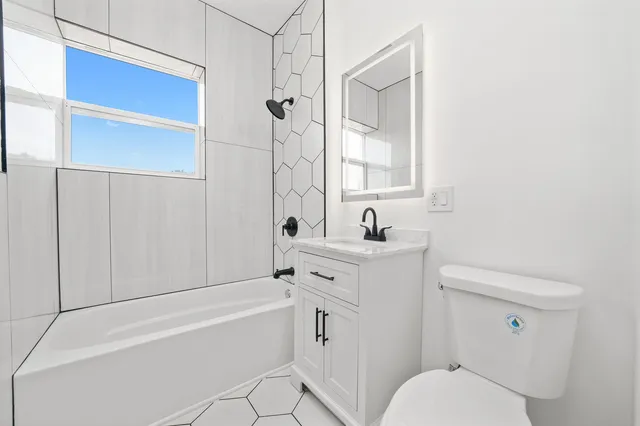 a bathroom with a toilet sink and shower