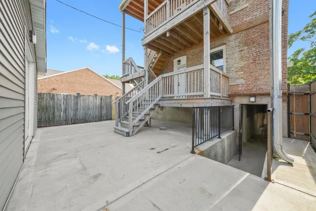 a view of a house with a wooden fence