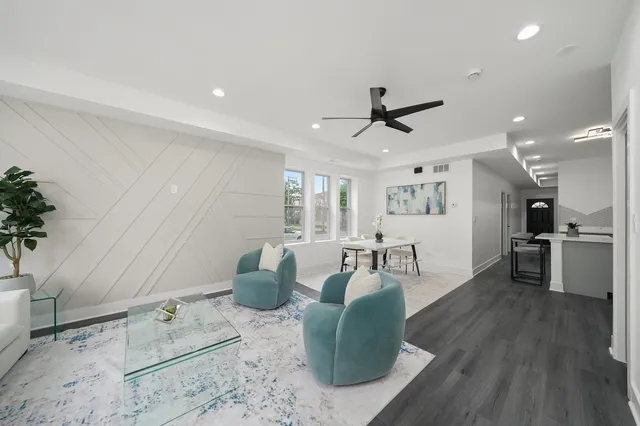 a living room with furniture and wooden floor