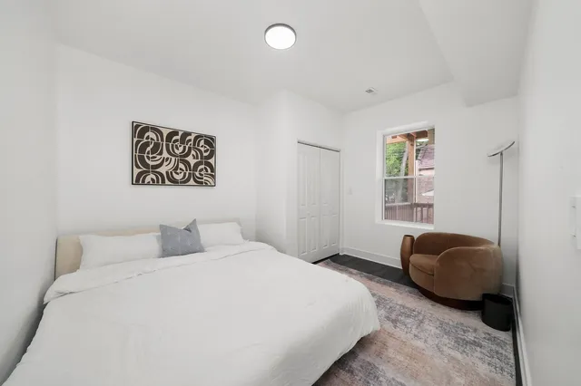 a bedroom with a bed and a window