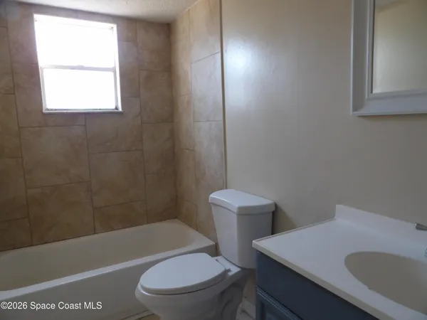 a bathroom with a sink a toilet and bathtub