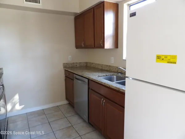 a kitchen with a sink and a refrigerator