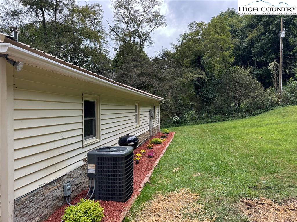 321 Skin Camp Creek Road Todd, NC 28684 - Photo 22 of 29 a front view of a house with a yard