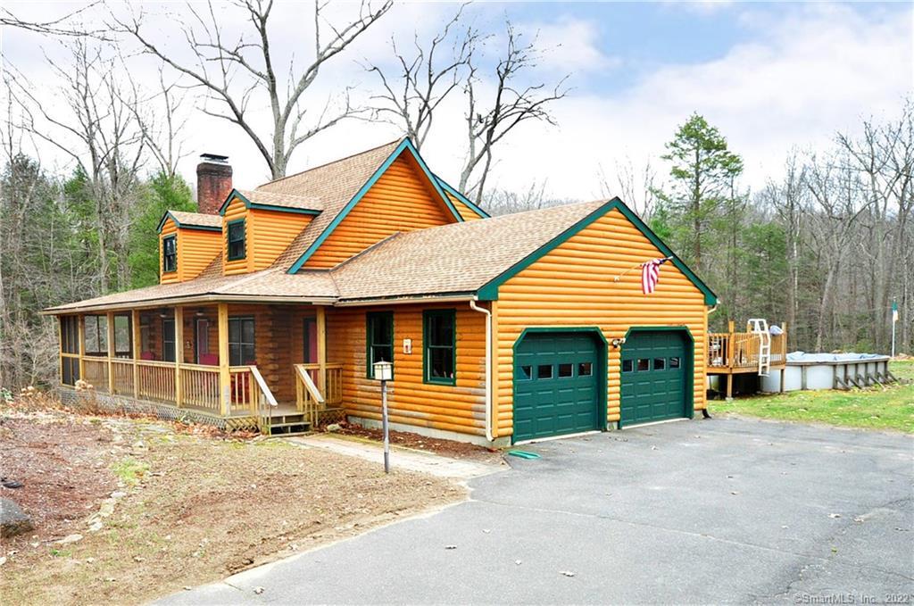 a view of a house with a yard and fence