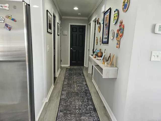 a hallway with painting on the wall