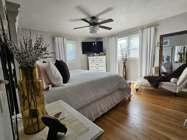 a bedroom with bed and glass door