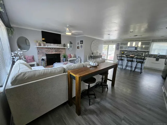 a living room with furniture a fireplace and a flat screen tv