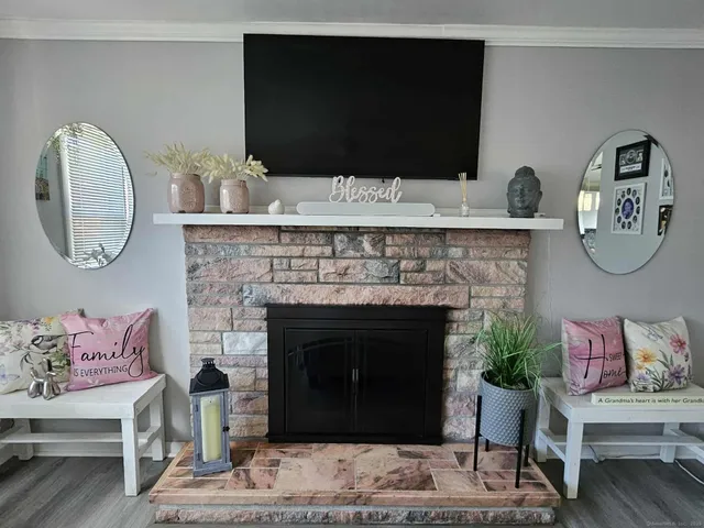 a living room with a fireplace and a flat screen tv
