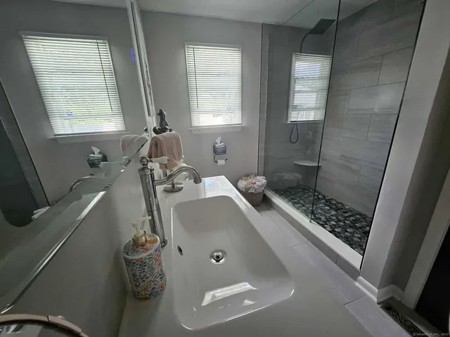 a bathroom with a tub sink and shower